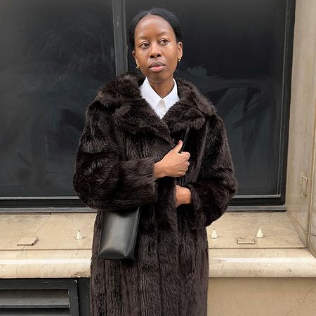 a woman wearing a dark brown fur coat