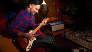 Man plays Positive Grid Spark amplifier with electric guitar