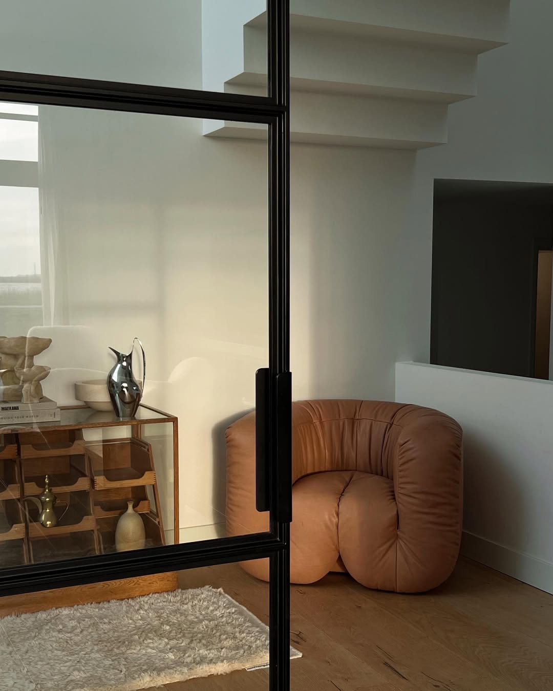 Brown chair in a room with neutral decor