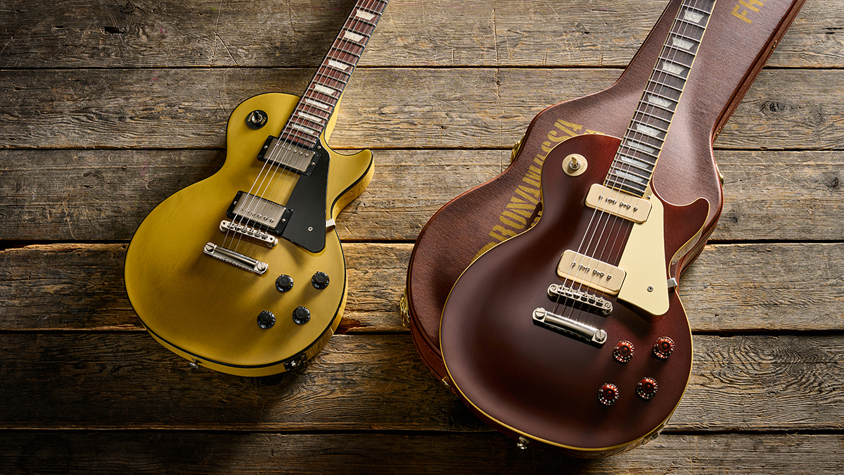 Detail of two guitars on a wooden floor: the Epiphone Joe Bonamassa 1955 Les Paul Standard and Gibson Les Paul Standard 50s