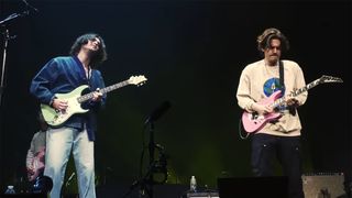 Alexander 23 (left) and John Mayer (right) performing live together