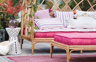 Close up of pink outdoor sofa and geometric patterned stool