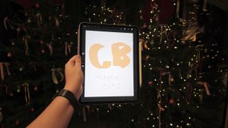 Apple event Battersea, holding an iPad Air with a CB illustration using procreate