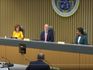 FCC Commissioners Anna Gomez (left) and Olivia Trusty (right) with FCC Chair Brendan Carr (center) during the May Open Meeting. 