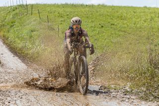 Sofia Gomez Villafane uses her mountain bike skill set to easily naviagte a muddy descent.