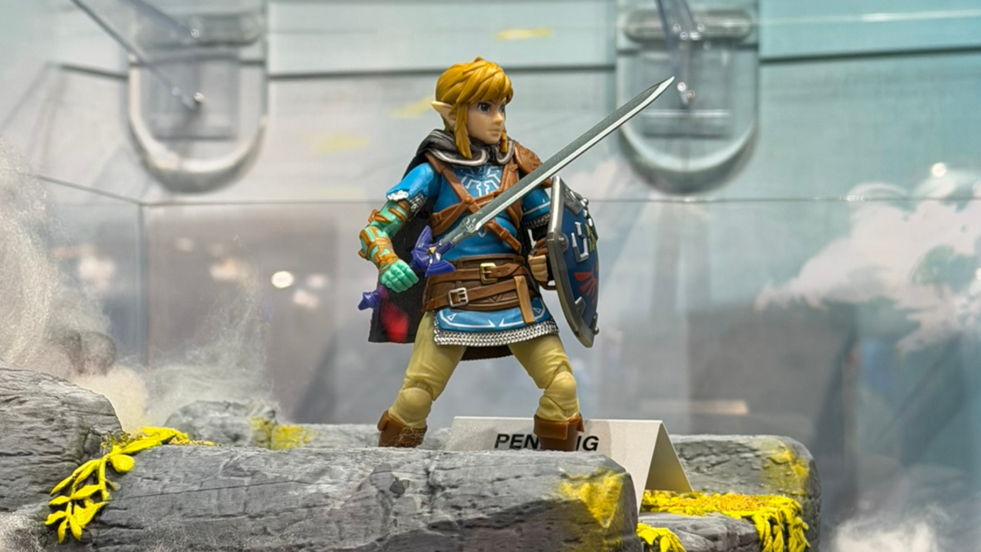 A Link action figure from Tears of the Kingdom stands with Master Sword and Hylian Shield ready on a sky island