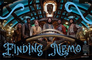 Six of the cast of Nautilus standing behind the helm of the sub.