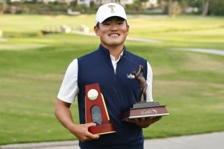 Hiroshi Tai holds up the NCAA Division One Men's Championship trophy