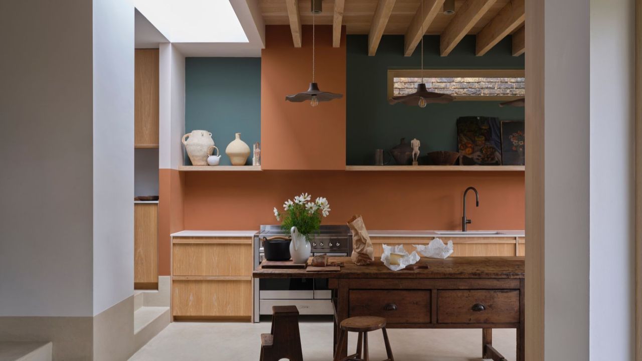 modern kitchen with muted orange and teal walls