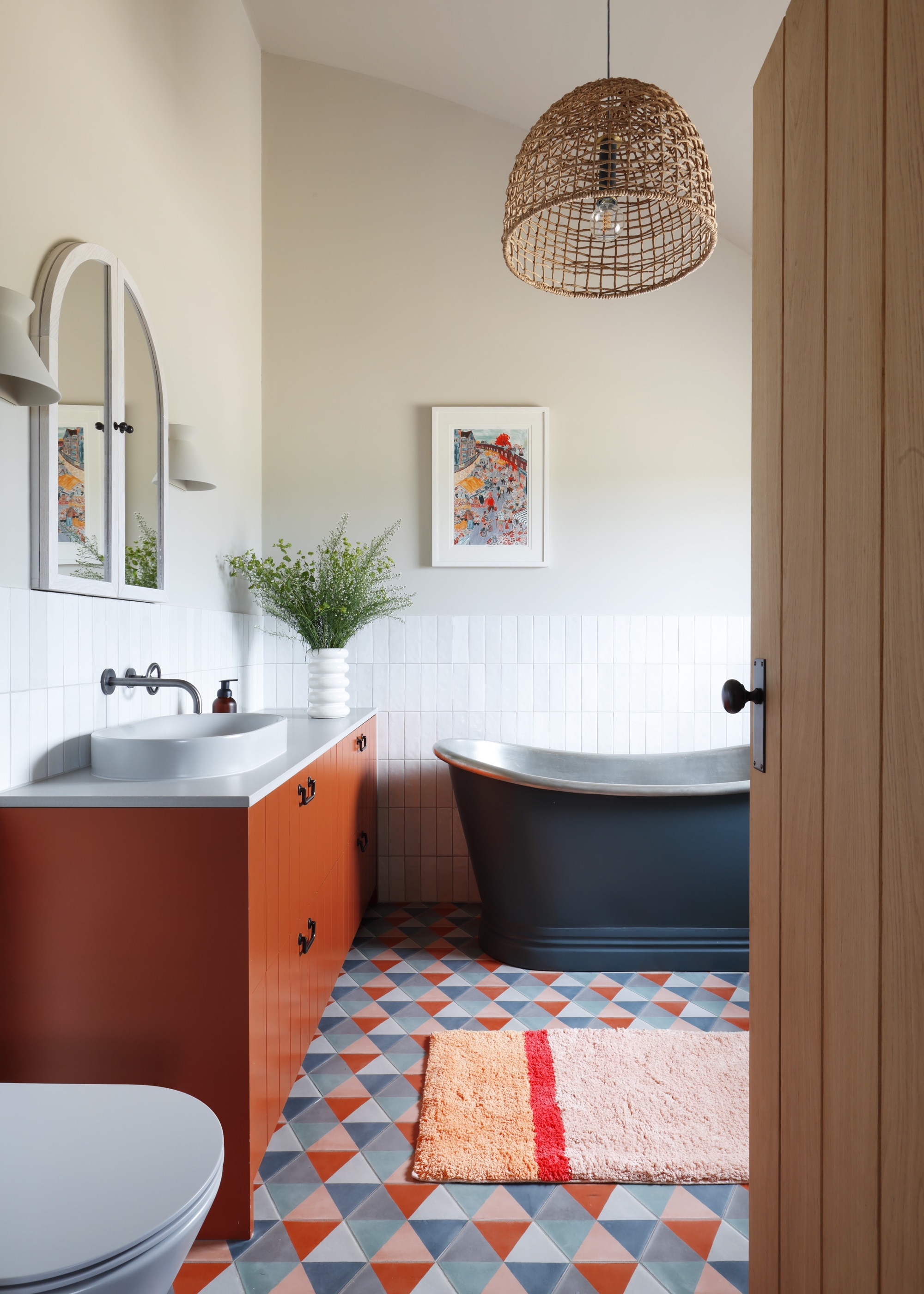 white bathroom with blue tin bath and orange vanity unit