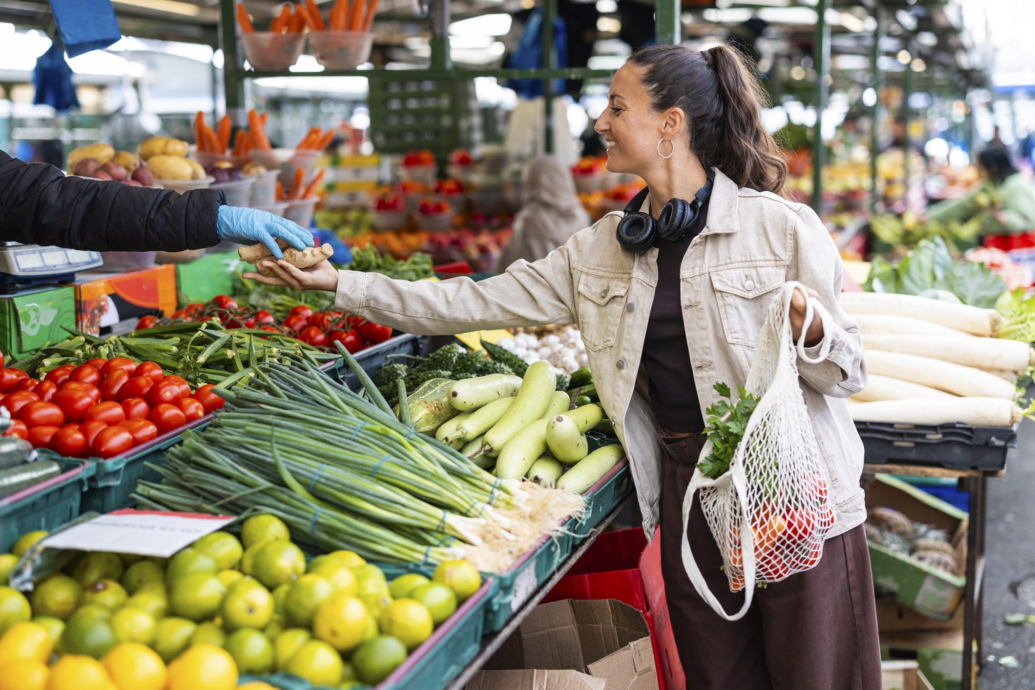 Woman shopping at a local market buying fresh produce representing UK inflation
