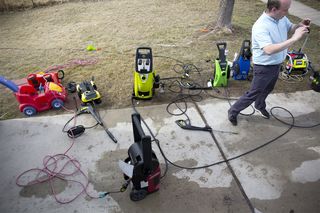 Best pressure washers: A reviewer tests out several different pressure washers, using them to clean garden toys and the dirty yard flooring