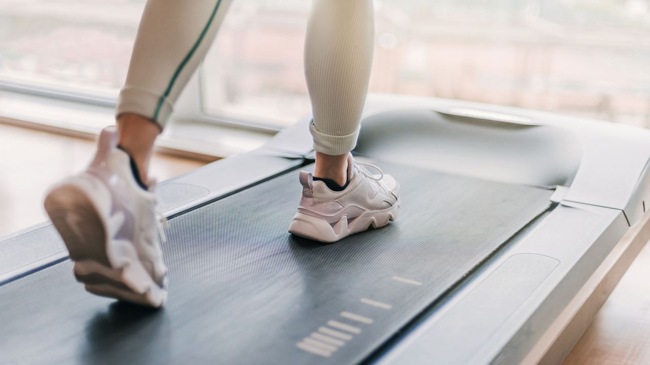 Best under-desk treadmills: image shows woman&#039;s feet on treadmill