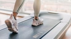 Best under-desk treadmills: image shows woman's feet on treadmill