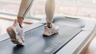 Best under desk walking treadmills: image shows woman's feet on treadmill