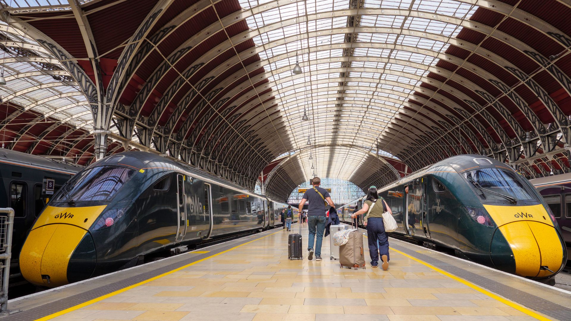 People boarding GWR trains on the platform at Paddington Station, London, UK.