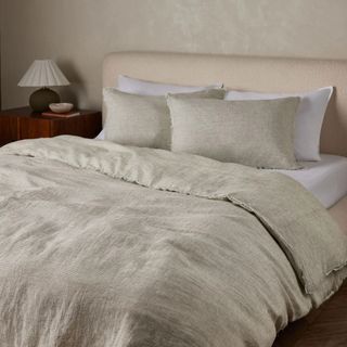 Luxury bedroom with stone colored linen bedding on double bed