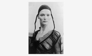 black and white image of a lady with a netted top and head wrap
