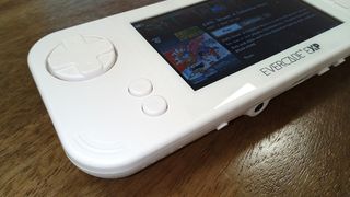 Evercade EXP review; a white handheld games console on a wooden table, close up of a d-pad