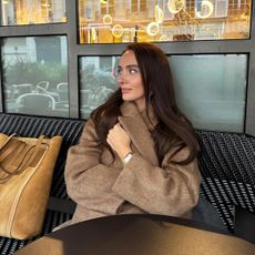 Influencer Liv Perez wearing a camel coat in Paris