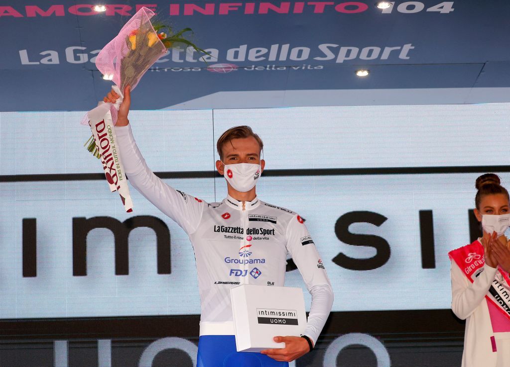 Team GroupamaFDJ rider Hungarys Attila Valter celebrates the best young riders white jersey on the podium after the fourth stage of the Giro dItalia 2021 cycling race 187 km between Piacenza and Sestola EmiliaRomagna on May 11 2021 Photo by Luca BETTINI AFP Photo by LUCA BETTINIAFP via Getty Images