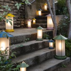 The Pooky Stefan lanterns by The Novogratz lit up and lining garden stairs in all the different colours and sizes available