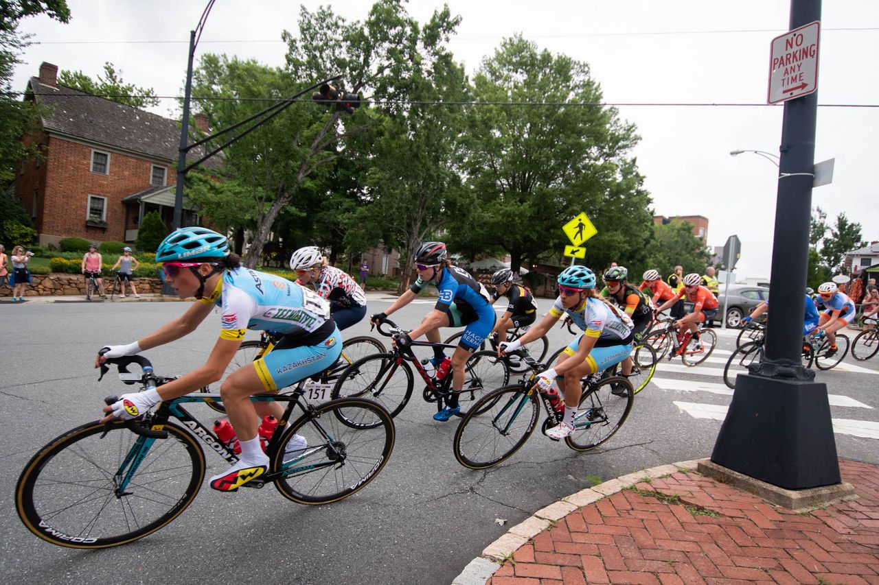 The women's peloton takes a corner during the road race at the Winston-Salem Cycling Classic