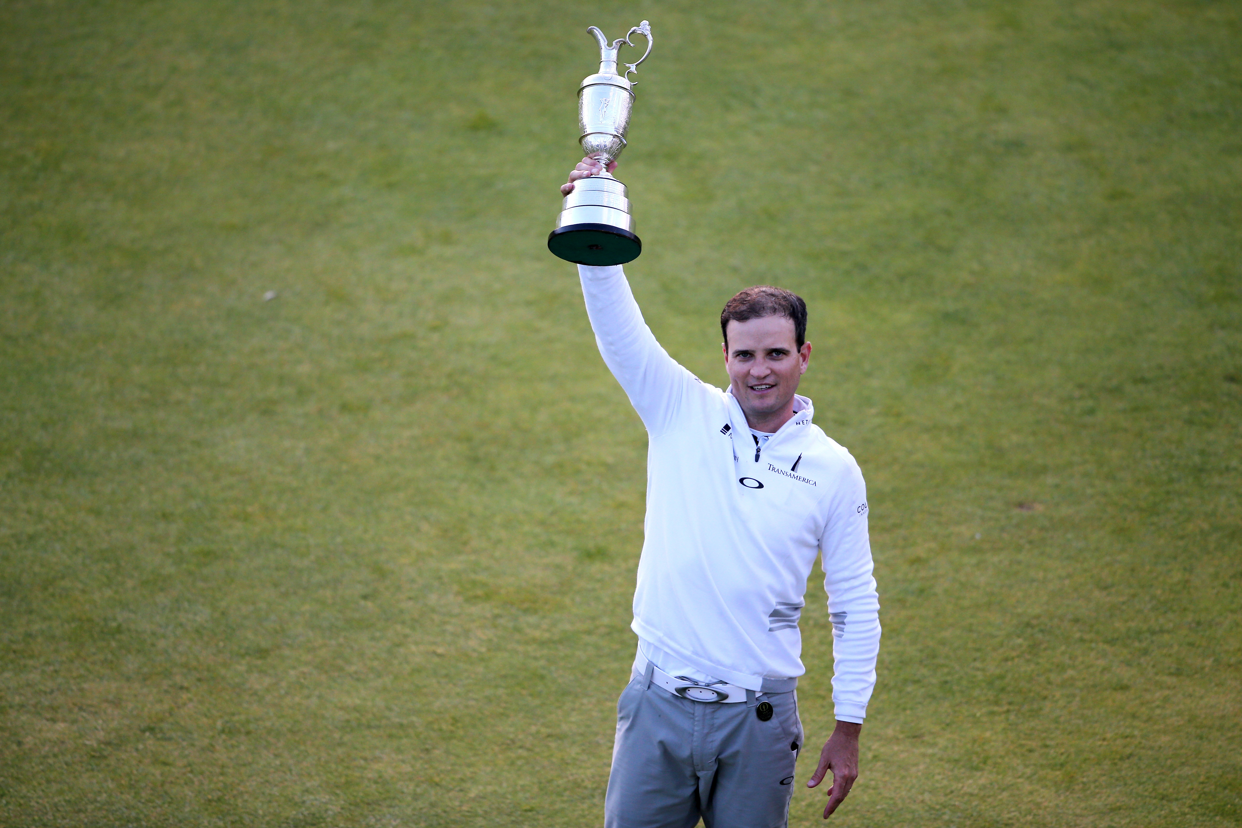 Zach Johnson holds the Claret Jug aloft at the Home of Golf, St Andrews in 2015