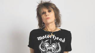 Chrissie Hynde, the lead singer with Pretenders, stares into the camera wearing a Motorhead T-shirt
