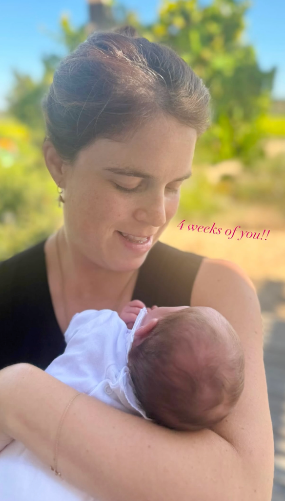 Princess Eugenie looking down at her daughter Adelaide