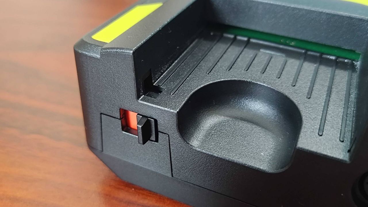 Close up of Hyperkin Retron GX card slot on woodgrain desk.