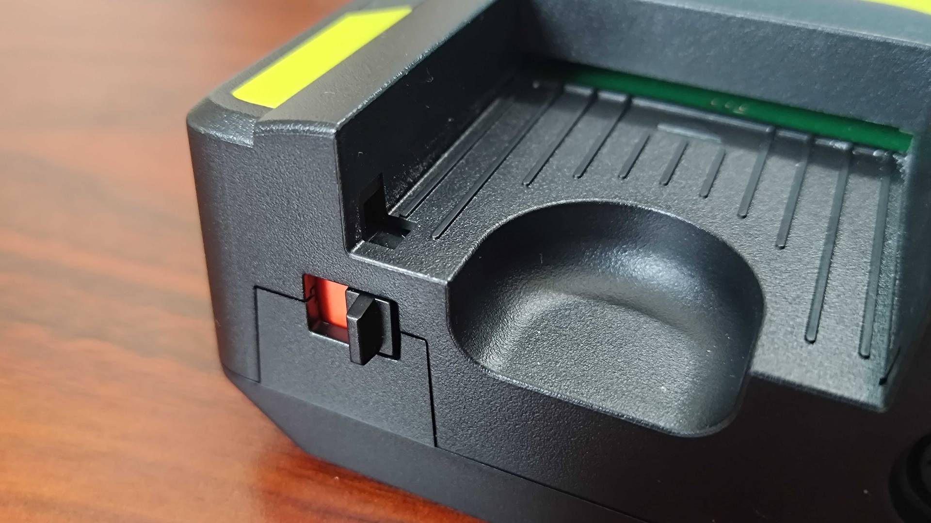 Close up of Hyperkin Retron GX card slot on woodgrain desk.