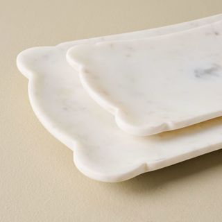 Two scalloped marble decorative trays from Magnolia Home