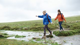 hikers on stepping stones