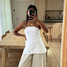 Influencer wears a white strapless top.