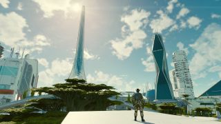 Still from the space game Starfield. In the foreground on the bottom right there is a man wearing an astronaut spacesuit, but instead of a helmet he is wearing a dark cowboy hat. He is standing overlooking a big futuristic city with several very tall buildings made out of white metal and dark glass. Dotted around are some green trees and dark moss growing on some of the buildings. The sun is shining high in the light blue sky which is dotted with white clouds.