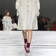 Dries Van Noten runway model wearing sleek trainers. 