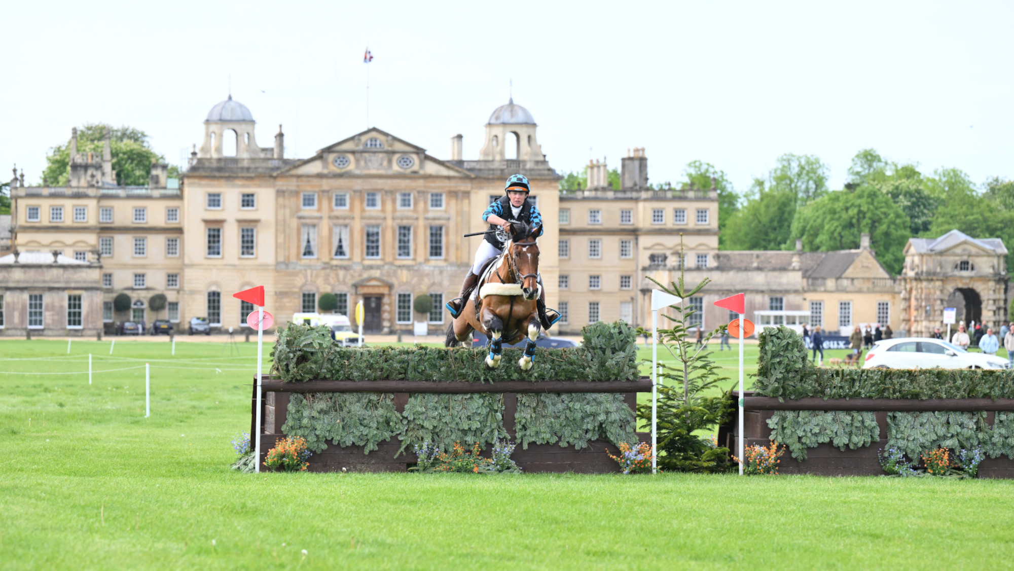 Pictured a horse and rider competing in cross-country. 
