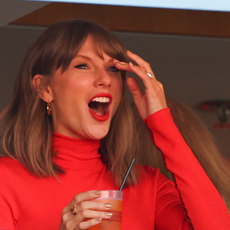 Taylor Swift wears a red turtleneck and a ruby ring at a Kansas City Chiefs game. 