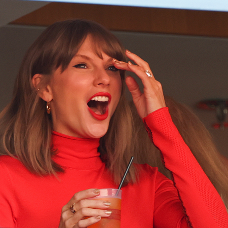 Taylor Swift wears a red turtleneck and a ruby ring at a Kansas City Chiefs game. 