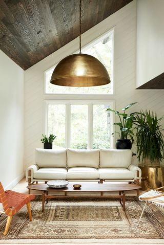 White living room with dark panelled ceiling