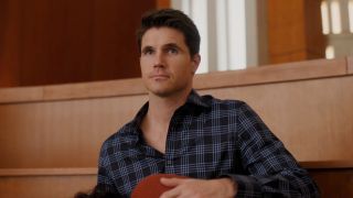 A screenshot of Robbie Amell as Nathan looking up in Upload.