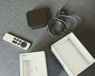 Apple TV 4K box and components laid out side by side in writer's home