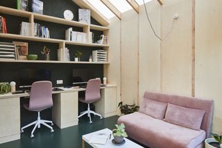 plywood interiors in garden home office in the garden with pink sofa bed