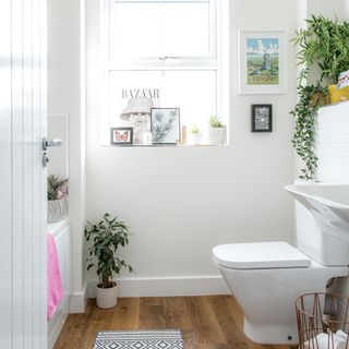 bathroom with wooden floor and commode