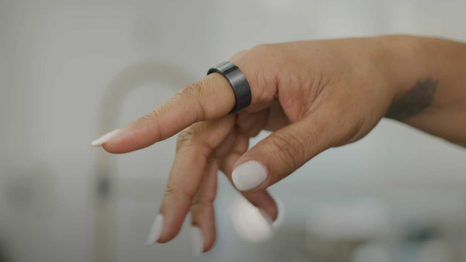 A hand wearing the Lotus Ring controller