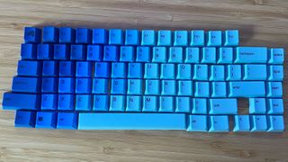 Glorious keycaps on a wooden desk in Ocean style design