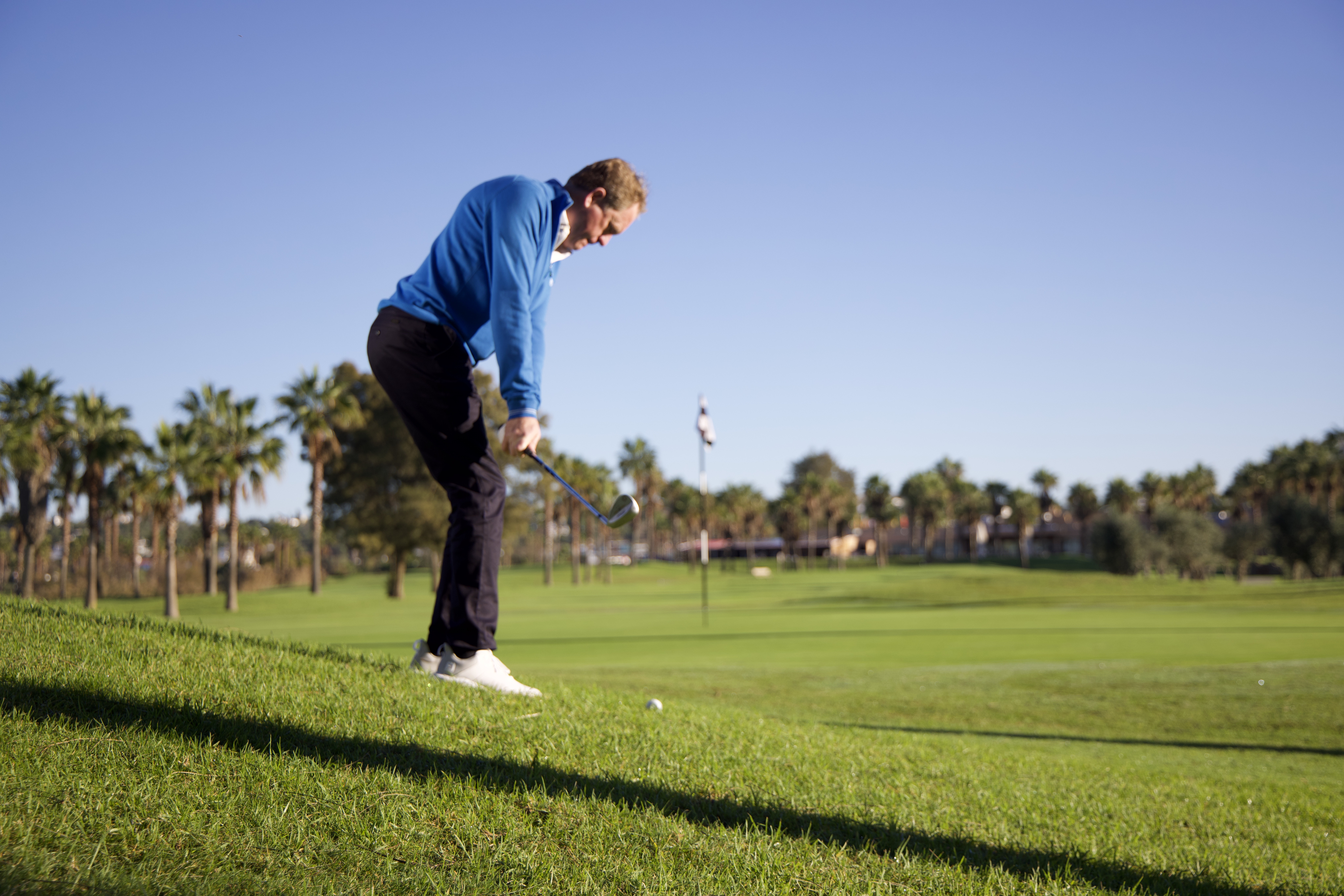 Keith Wood hitting a chip shot from a downhill lie