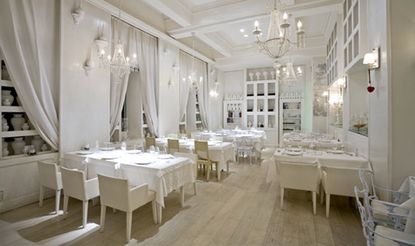 Restaurant with white interior and wooden flooring