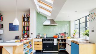 kitchen extension to victorian property with green feature wqall and otherwise white scheme photographed by bruce hemming